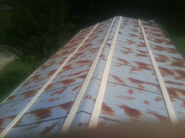 Rusted metal roof panels with new wood purlins before replacement — Storm Damage Roof Repair in Shorter by Roofing Brothers